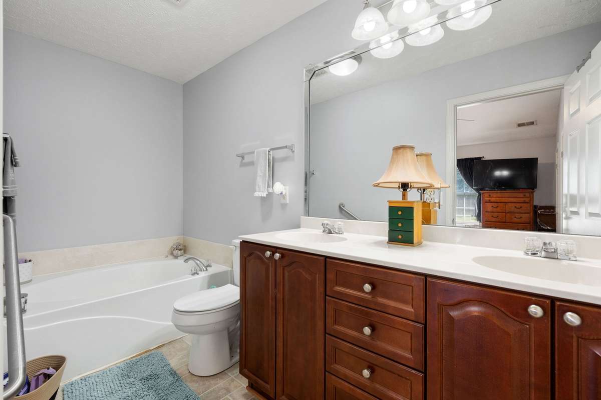 Primary bathroom also has a shower located behind the bathroom door