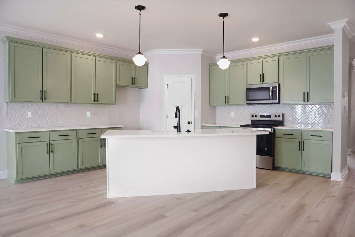 Custom Cabinets with quartz countertops. Chevron Subway Tile.