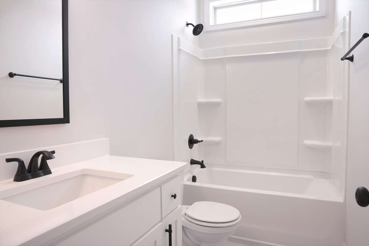 Guest bathroom down stairs. Natural lighting. There is a door going into the guest bedroom.