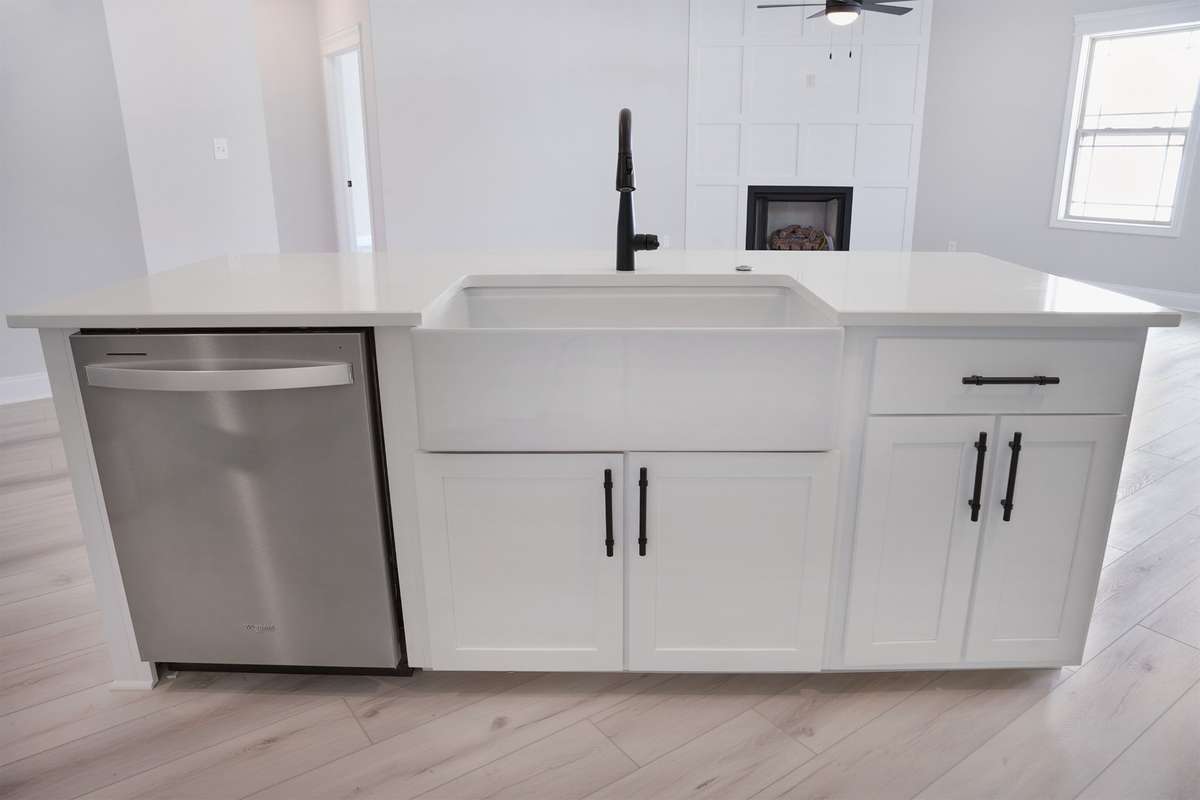 Island with quartz countertops and porcelain sink.