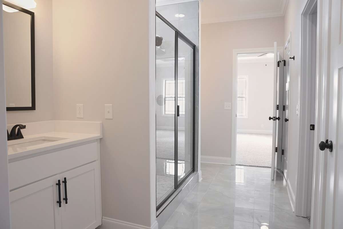 Master bathroom with huge closet separate vanities linen closet window in shower for natural lighting.
