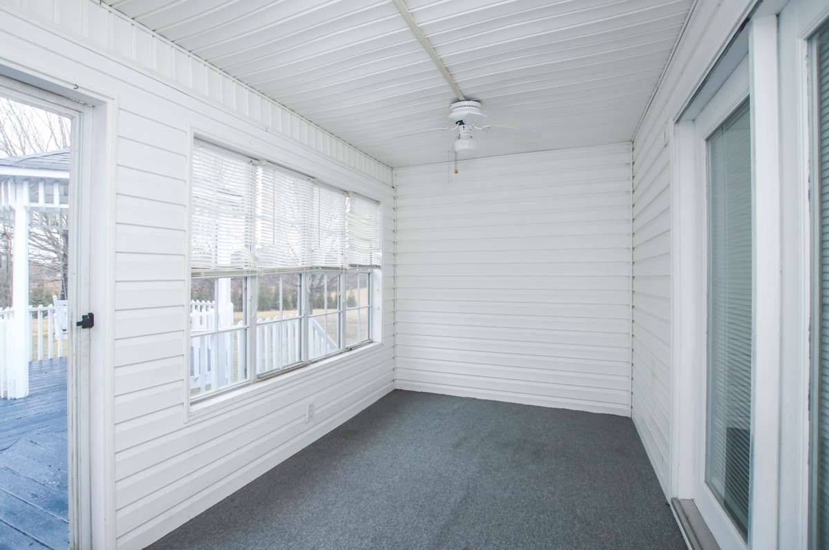 This is the Florida room which has indoor/outdoor carpet and lots of screened windows. You can see the gazebo and the deck from the window