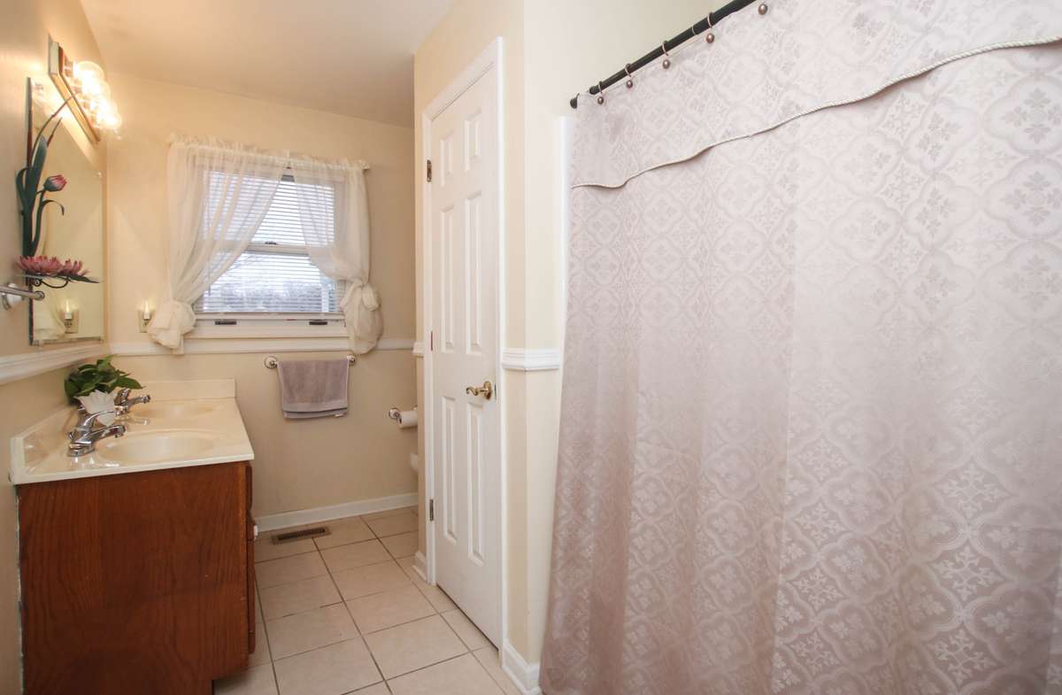 This is the secondary bath for the secondary bathrooms with double sinks and a utility closet