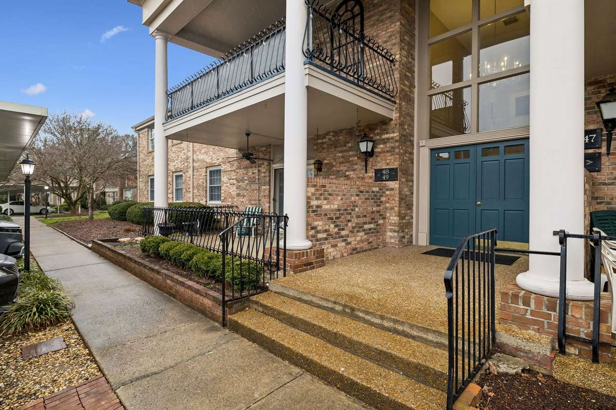 Front Door to Building. Two Assigned Parking Spaces in the Carport Area