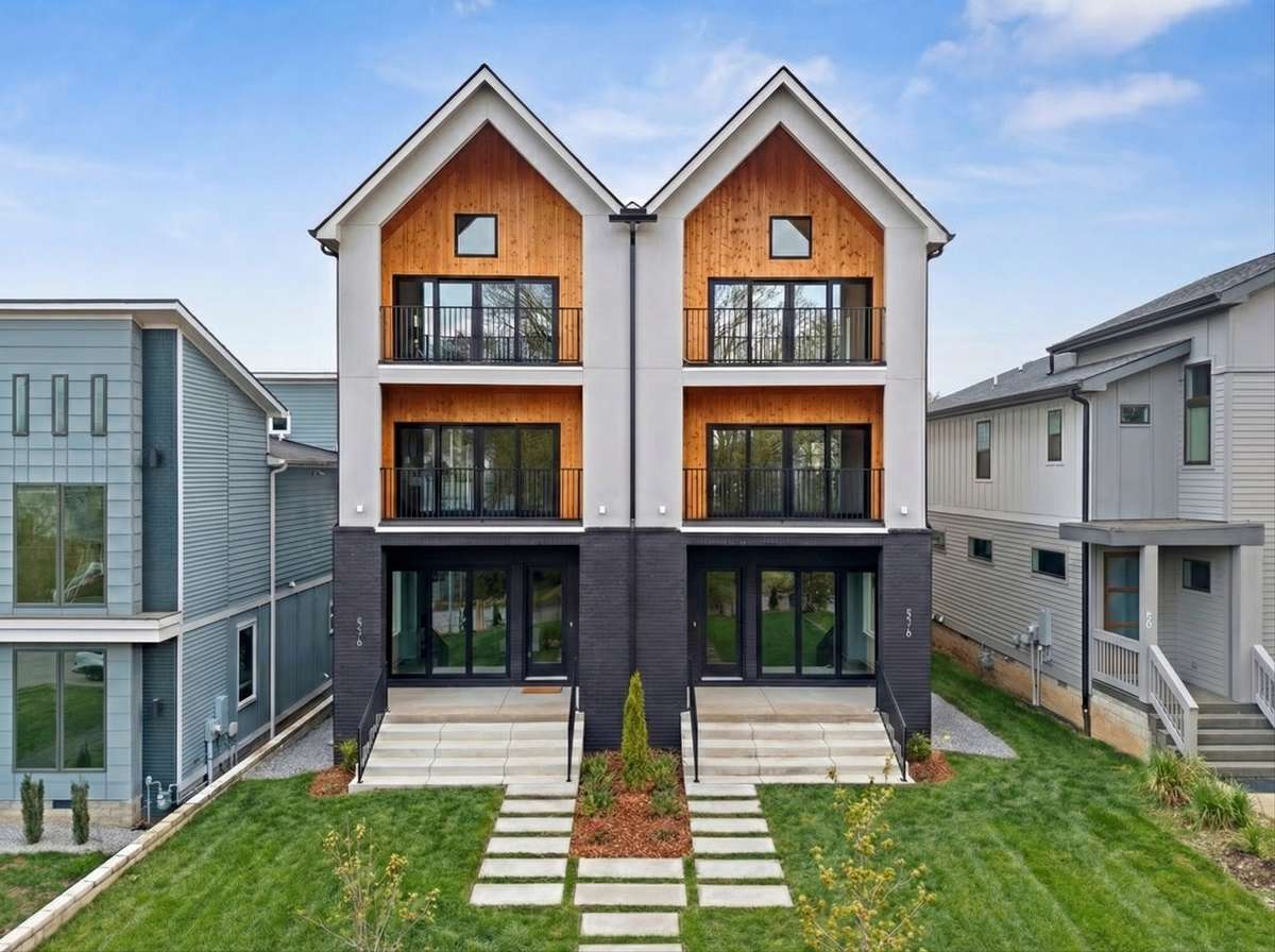 Stucco exterior with contrasting brick and beautiful wood accent