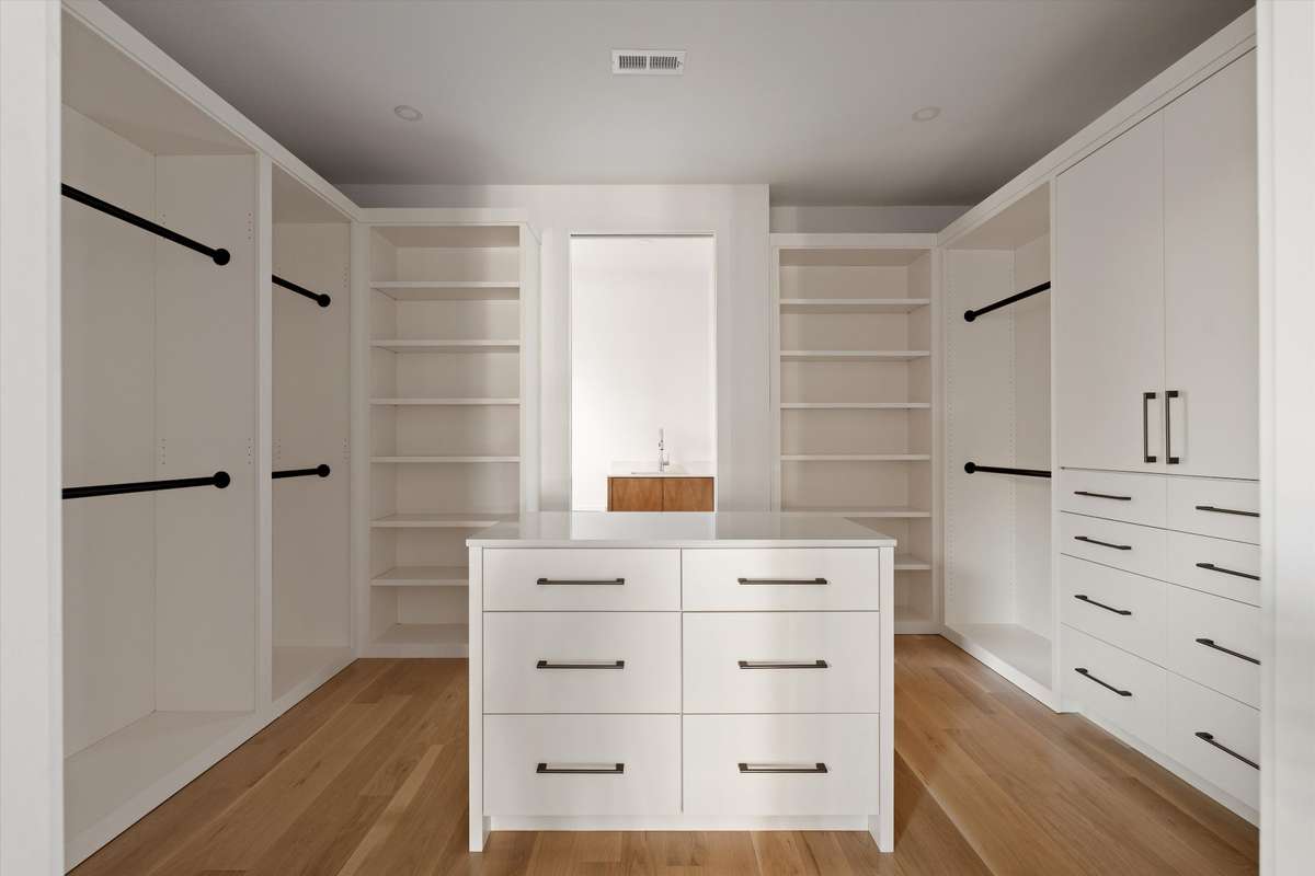 A beautifully designed custom closet is located just off of the primary suite, offering abundant storage and elevated functionality