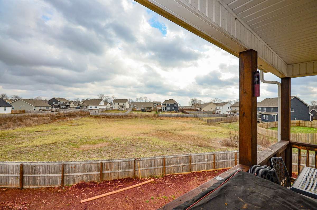 The property extends to the far reaches of the mowed area outside the fence in all directions.