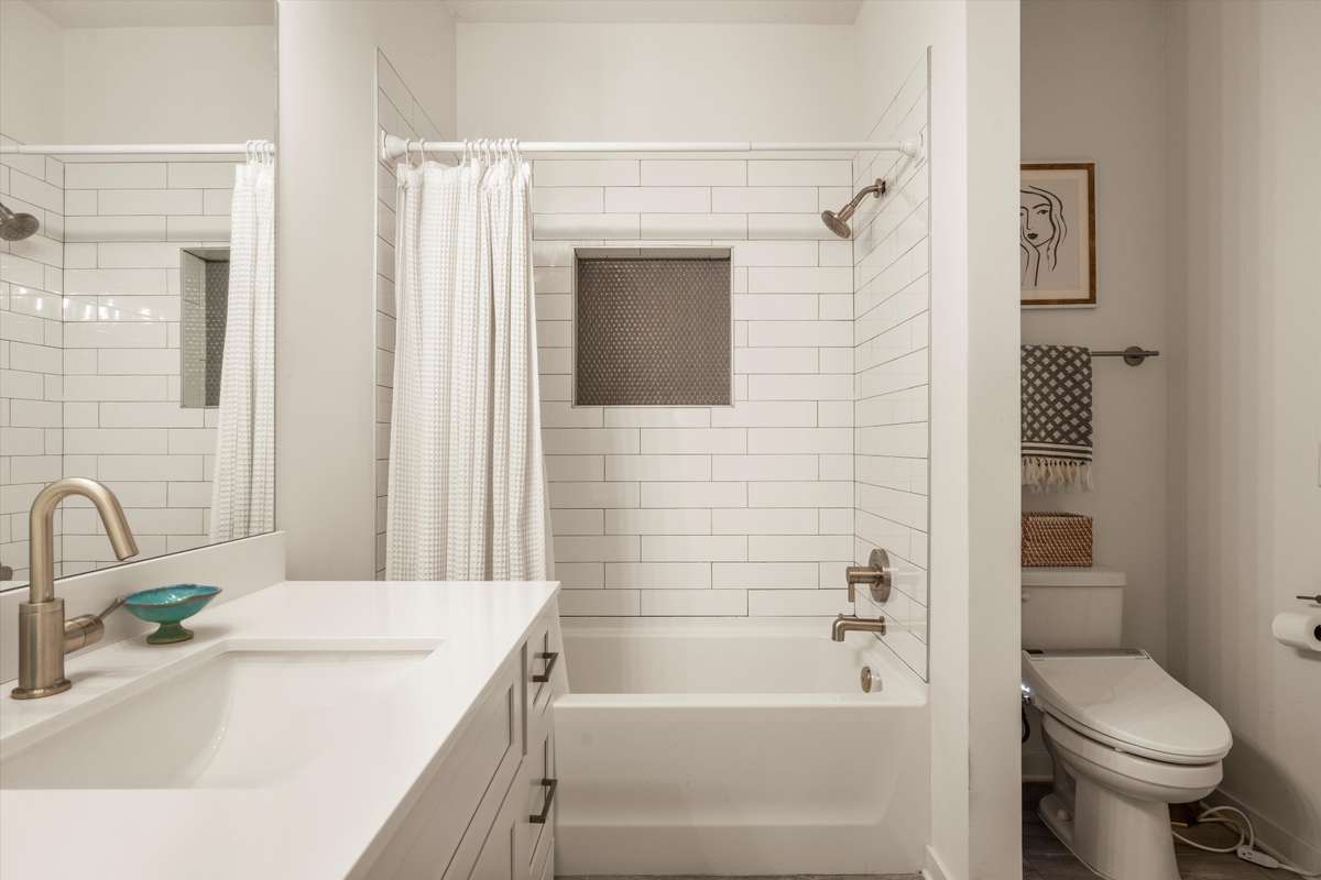 FULL BATHROOM WITH TILE FLOORS AND TILE SHOWER