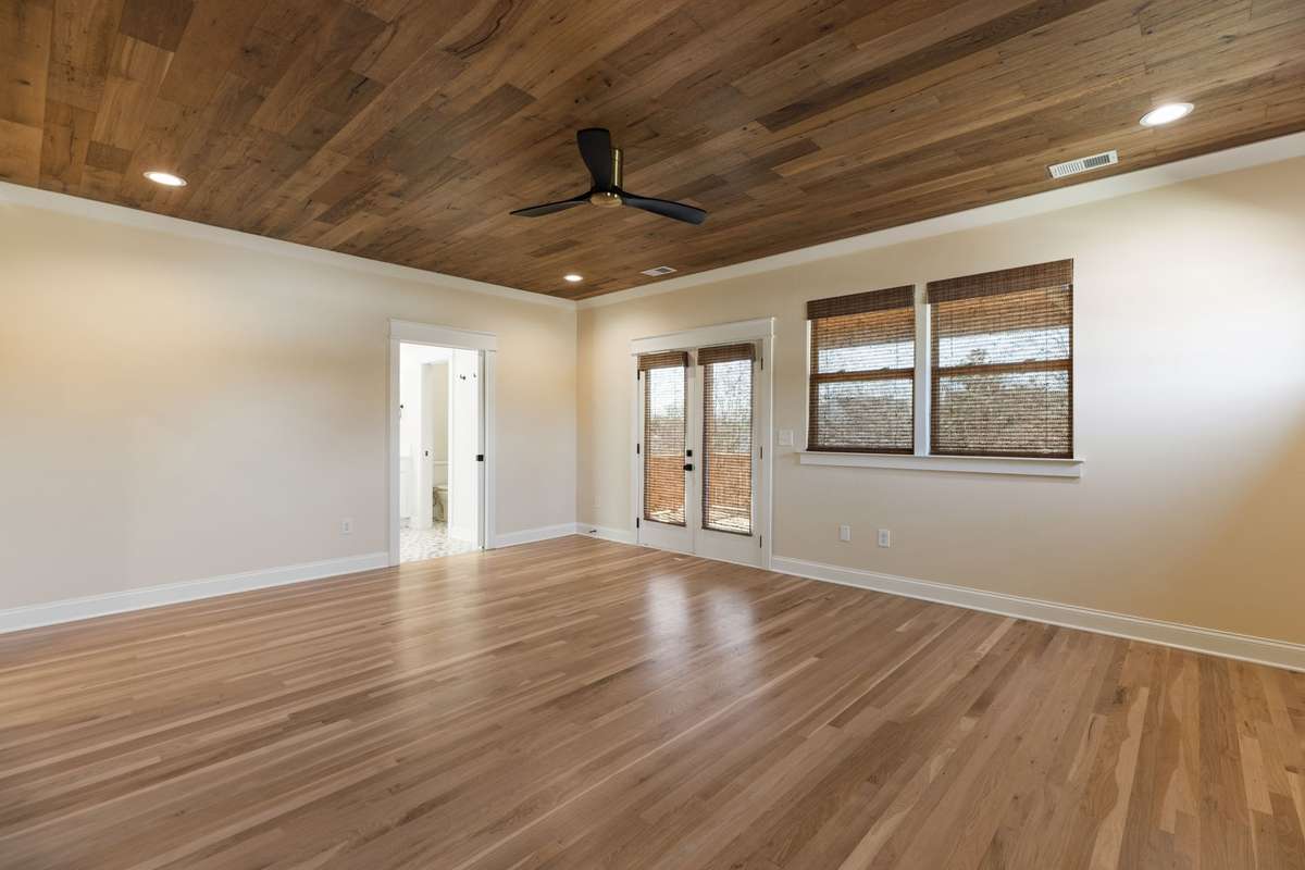 Designer Primary Suite. Upgraded ceiling. Custom blinds. Additional windows added in bedroom for even more natural light. Doors lead to upstairs balcony and covered porch overlooking East Nashville.