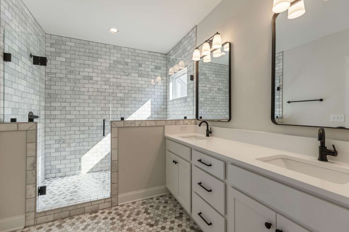 Massive walk in tiled shower with sunlight.