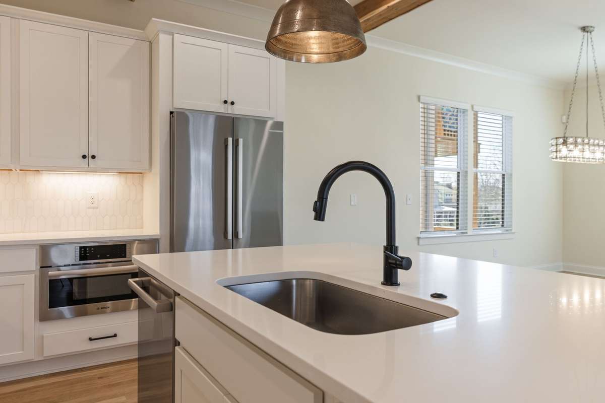 Large sink in island with additional cabinetry