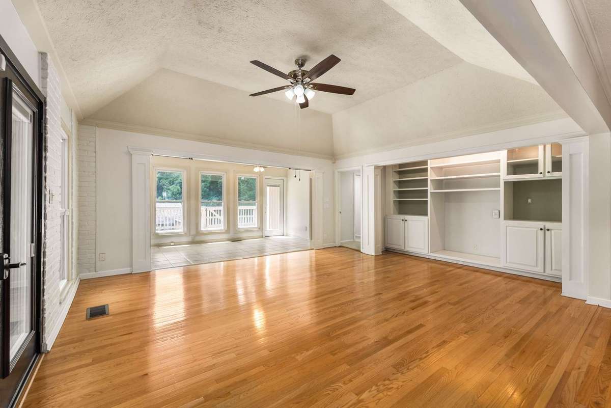 The Great Room with built in book shelves, a vaulted ceiling and plenty of natural light.