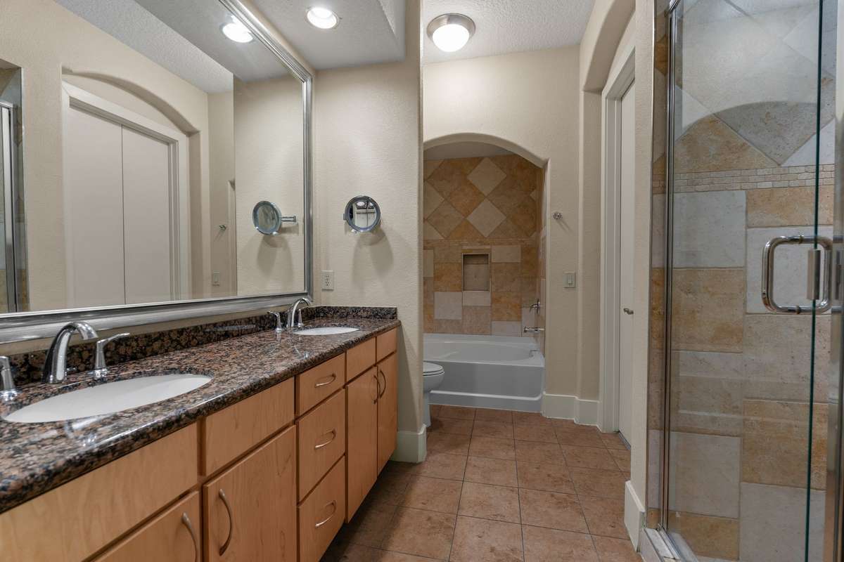 Primary ensuite bathroom featuring a walk-in shower AND soaker tub.