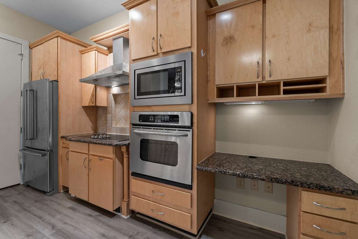 Kitchen layout with modern convenience, tons of storage space, mini-fridge, and new fridge.
