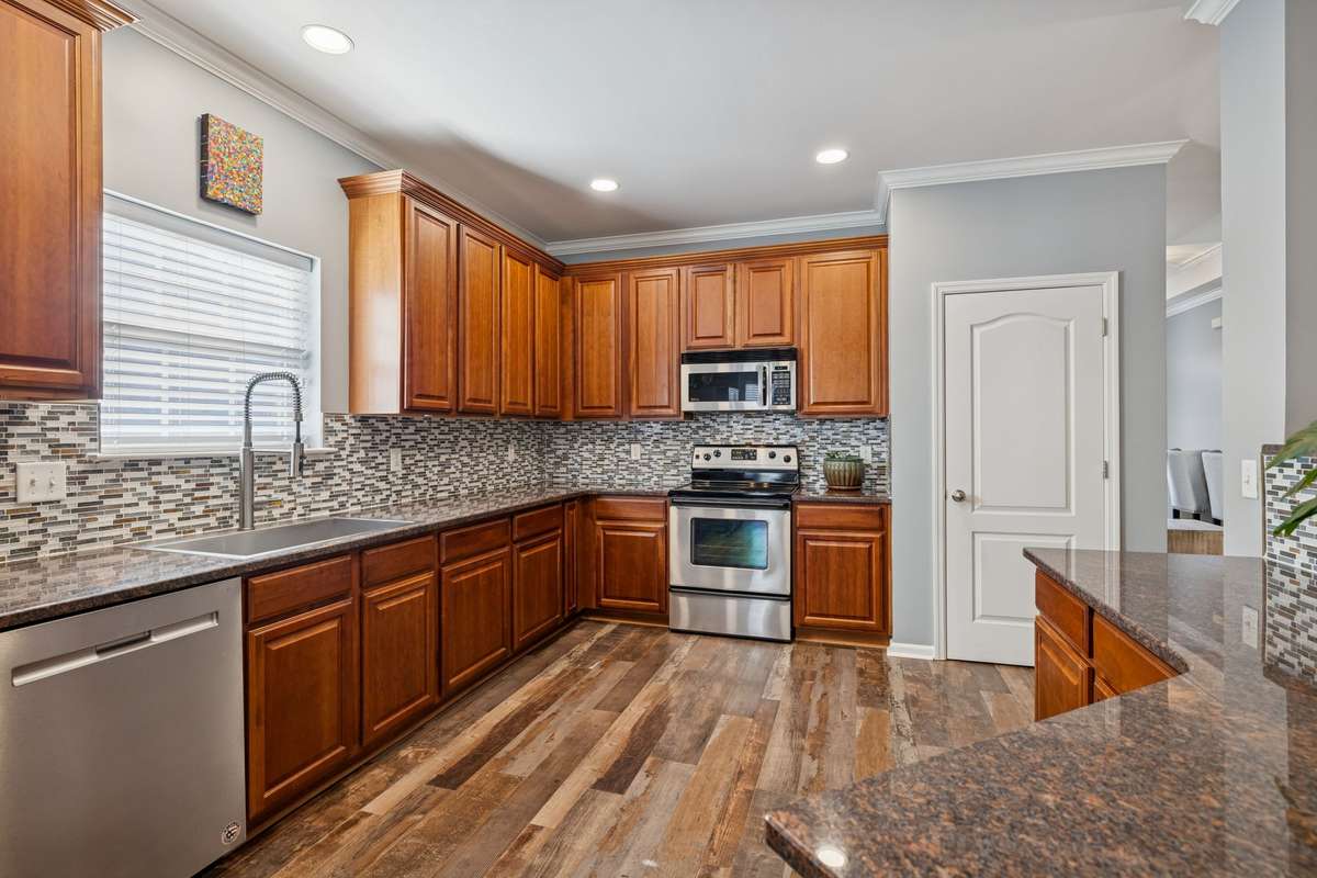 Kitchen - Notice the newly done recessed lighting with dimmer switches and the updated backsplash that sets the entire tone for the Kitchen.