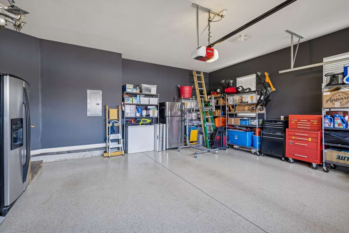 Two Car Garage - Freshly painted with epoxy floor.  This speaks volumes of how well maintained this home has been.  Not pictured is the new custom insulated double garage door with privacy double paned obscured glass.
