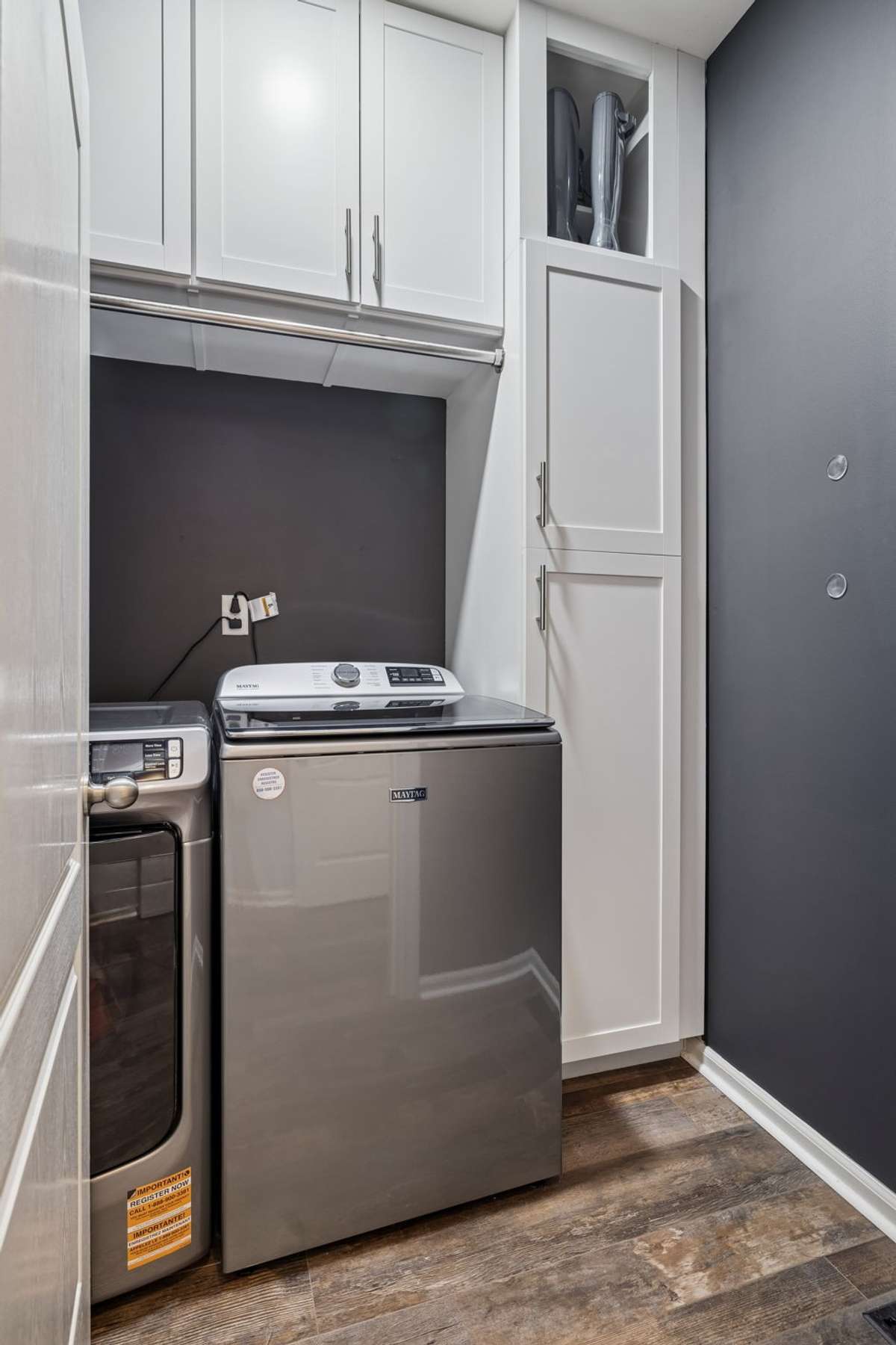 Laundry Room - Located on the main level.  Enjoy the updated white cabinetry that go to the ceiling, hanging bar, and freshly painted walls.