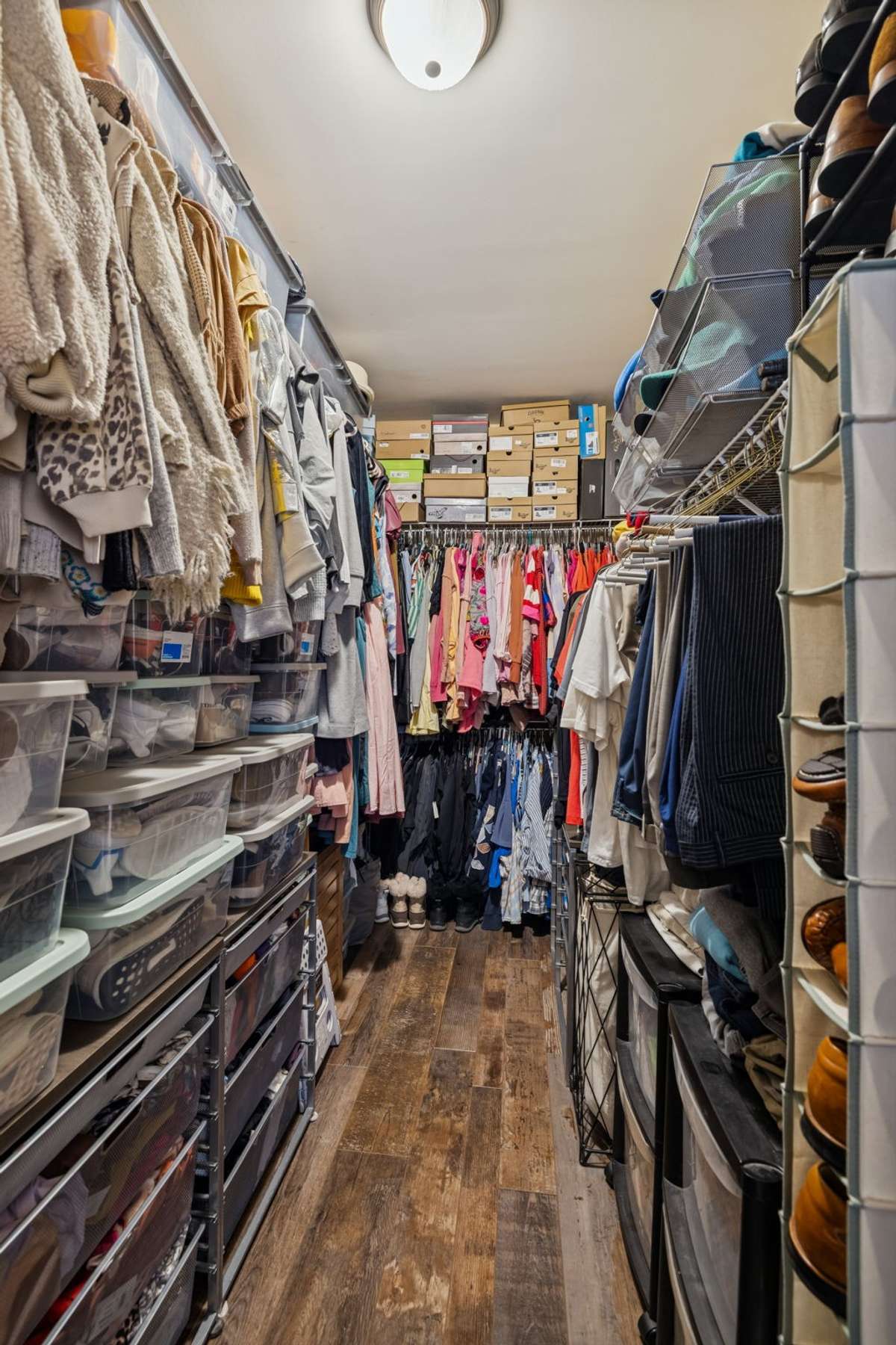 Primary Bedroom Closet - Very large, and runs the entire length of the primary bedroom with shelving at the back and down both long sides for maximum storage.
