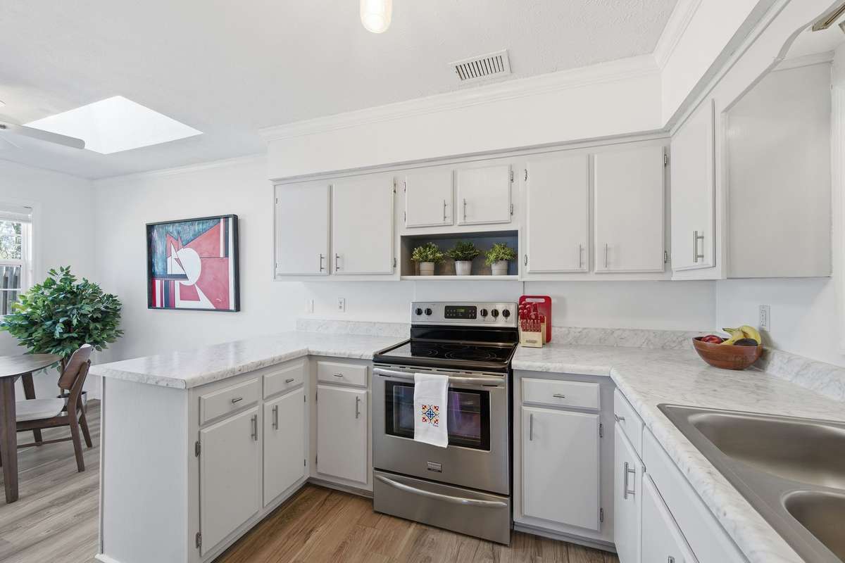 Kitchen has new stainless Stove, Refrigerator and Dishwasher. Kitchen bar area is large enough for stools at the bar and a table and chairs.