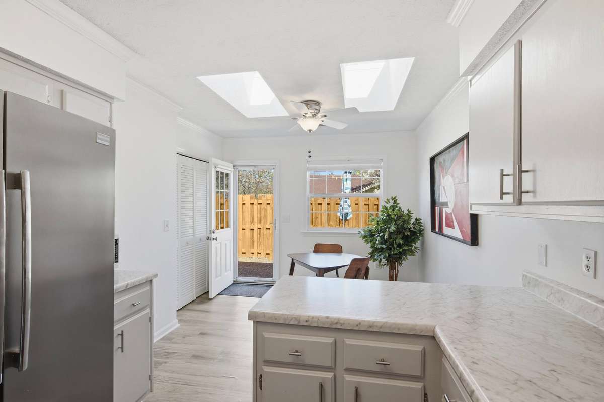 Kitchen is bright and cheery. Two skylights enhance the light over the eat-in area.