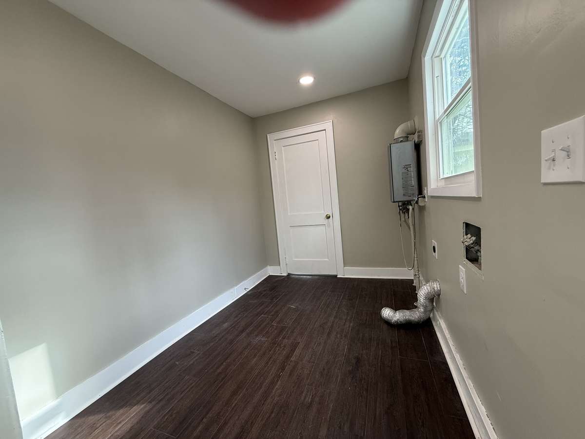 Laundry room with tankless hot water heater