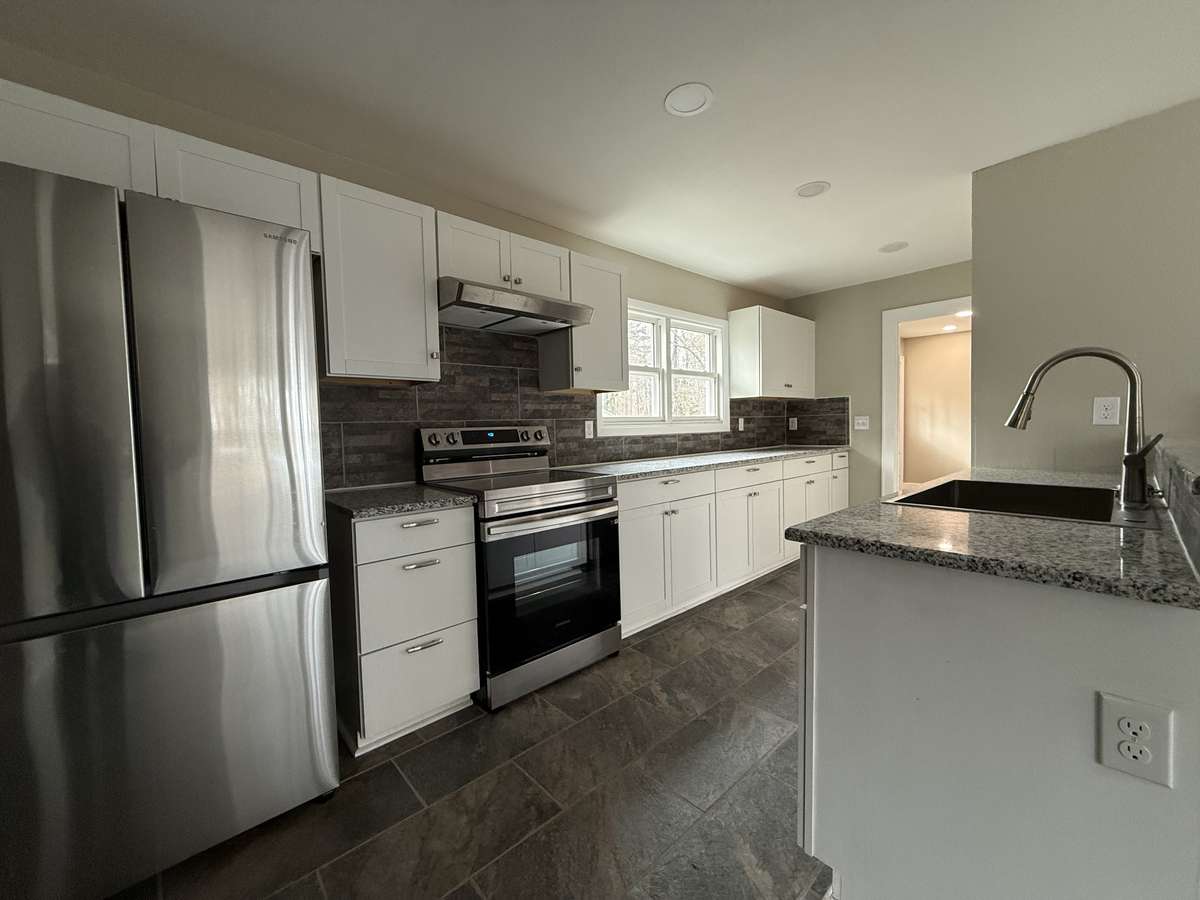 Large kitchen with new granite countertops and lots of counter space