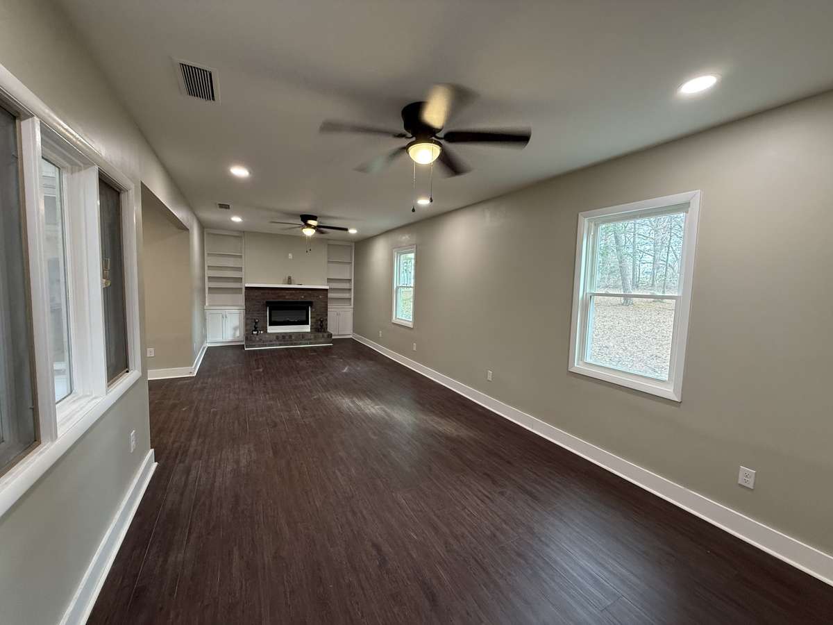 Large living room with electric fireplace with built-ins