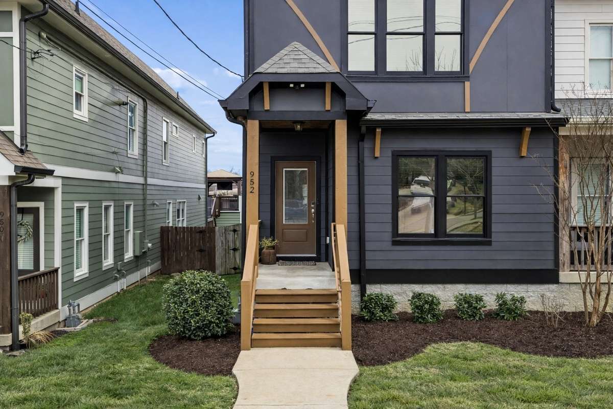 Welcoming front entry with clean lines, covered stoop, and curated curb appeal. This image has been virtually enhanced for marketing purposes only.