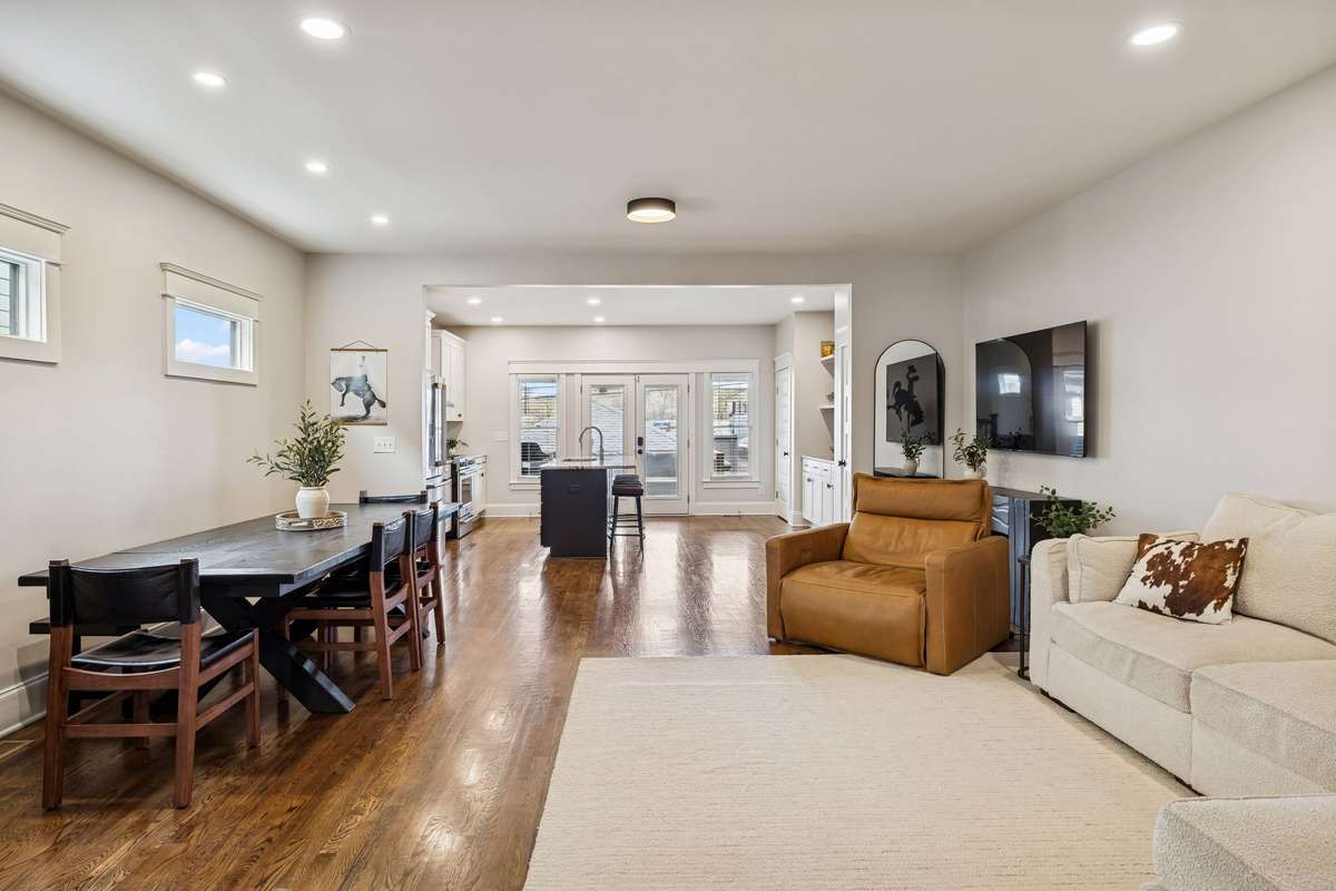 Spacious living room anchored by a fireplace, designed for both everyday living and entertaining.