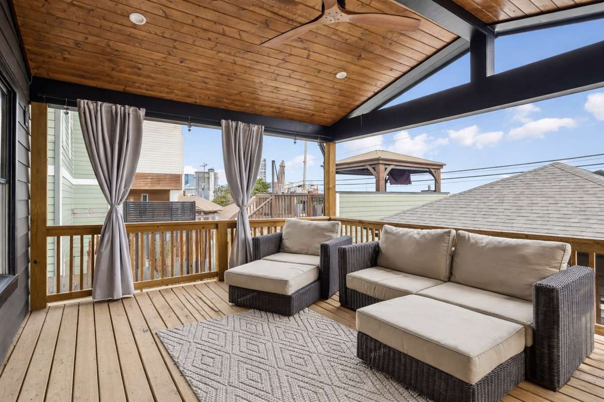 Covered outdoor living space with vaulted wood ceiling and plenty of room for seating.