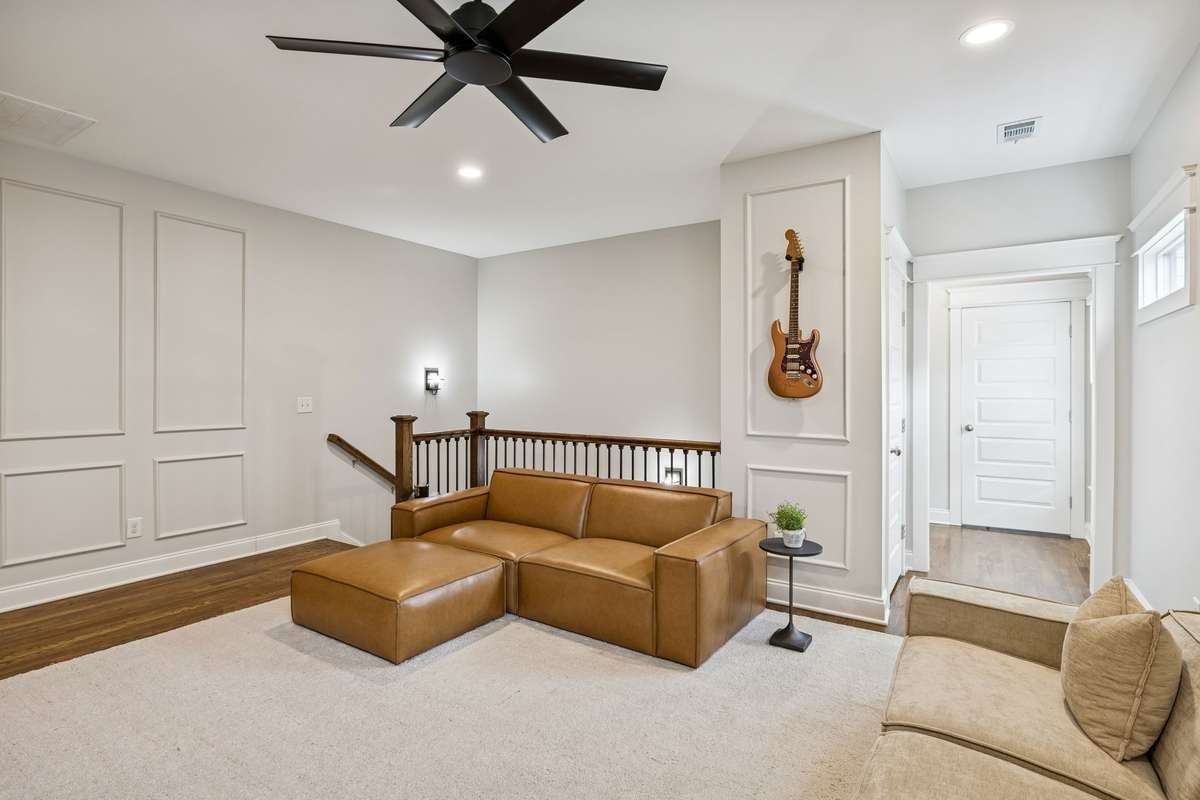 Upstairs flex space with natural light and room for lounge, office, or play area.
