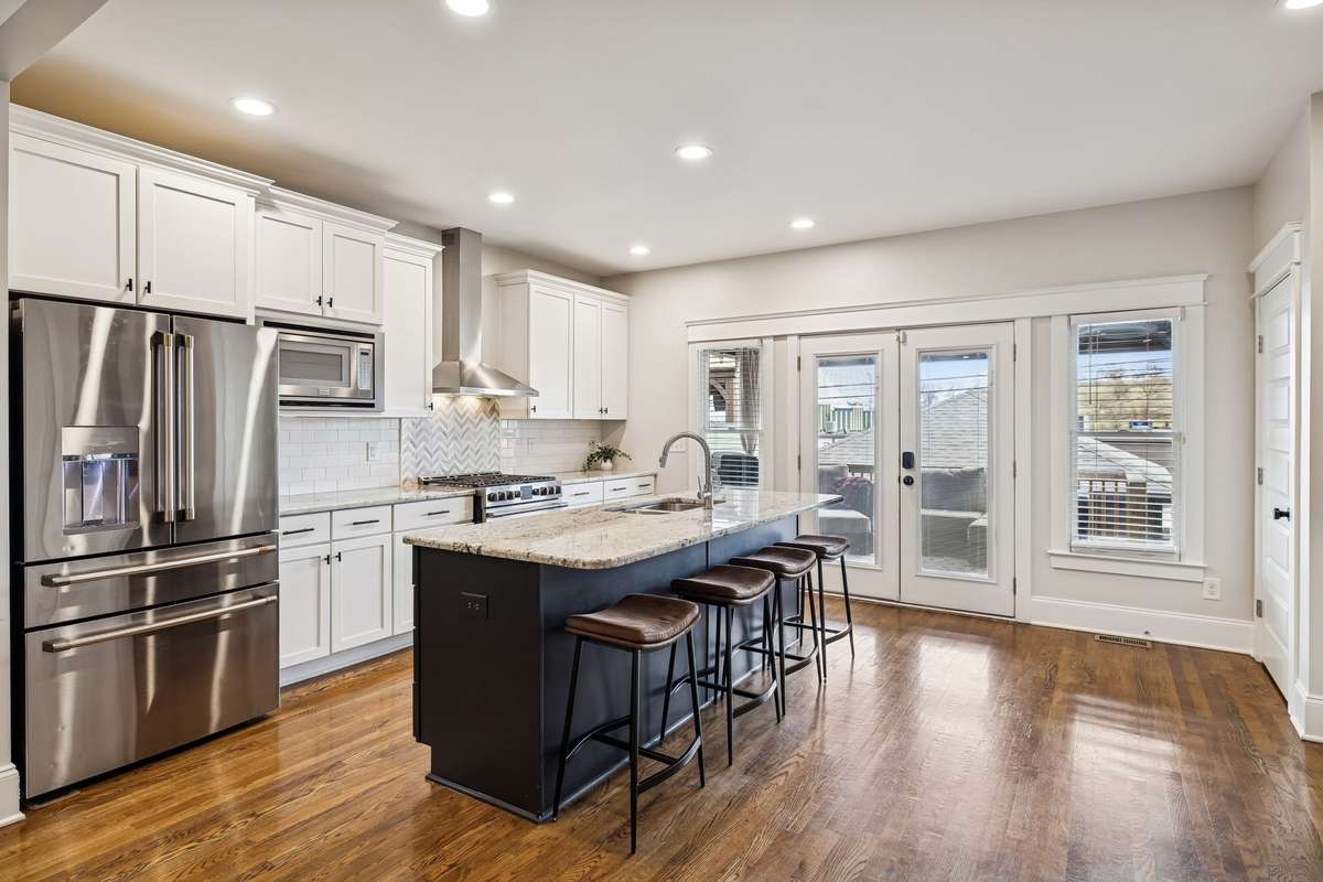 Kitchen with stainless appliances and island seating for casual dining.