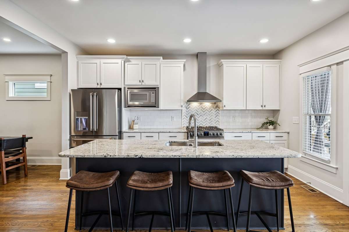Well-appointed kitchen with oversized island, ample storage, and direct access to outdoor living.