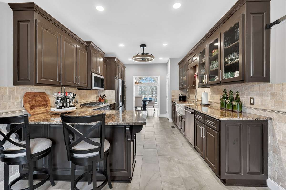 Kitchen has recessed lights and stylish fan light.