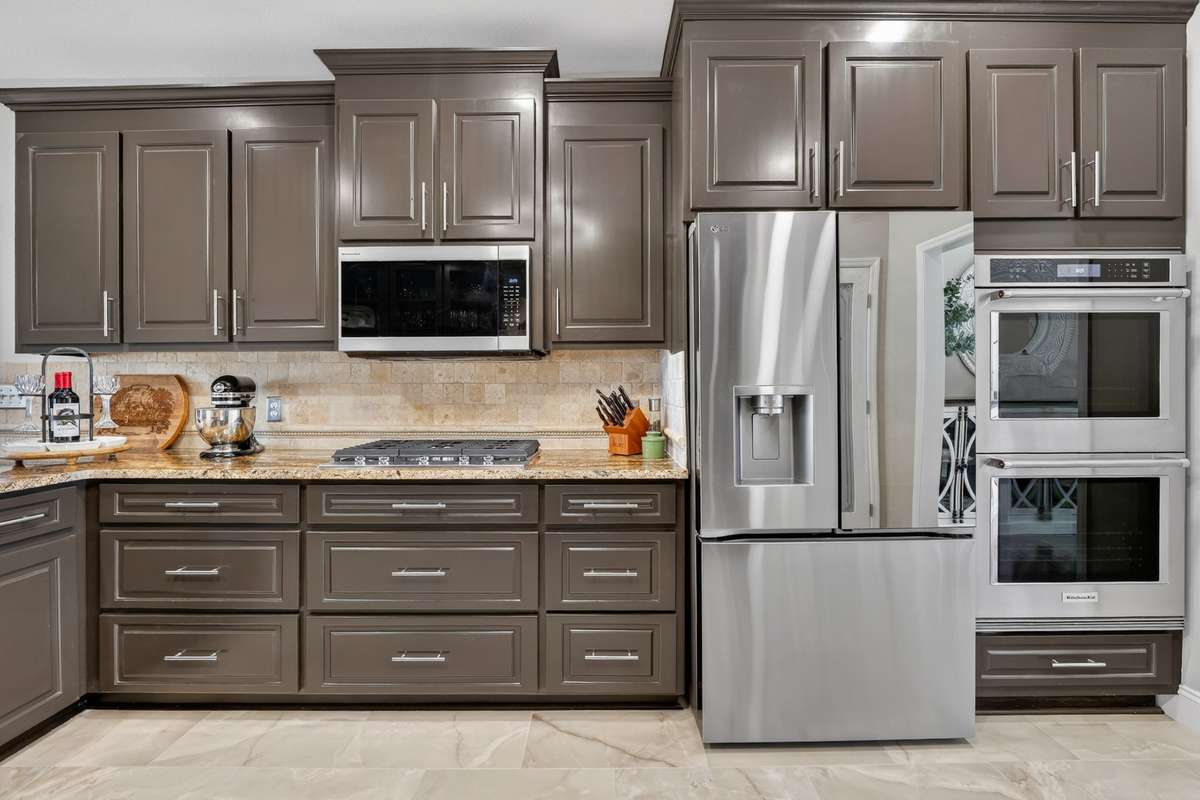 KitchenAid appliances including: gas cook top with 5 burners, microwave, double ovens and dishwasher. (Refrigerator does not stay)
