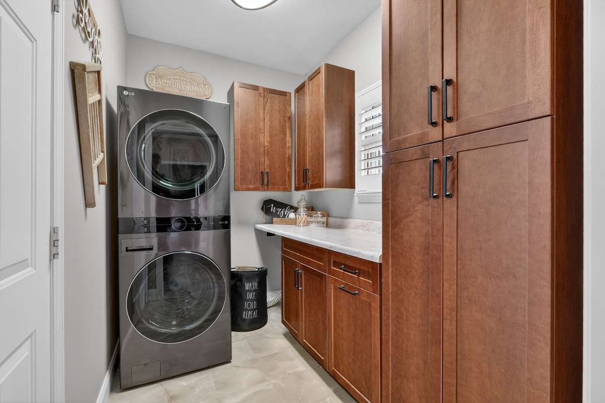 New laundry room cabinets. The 1st tall cupboard is on rollers to provide easy access to the electric panel. (Washer & dryer do not stay)