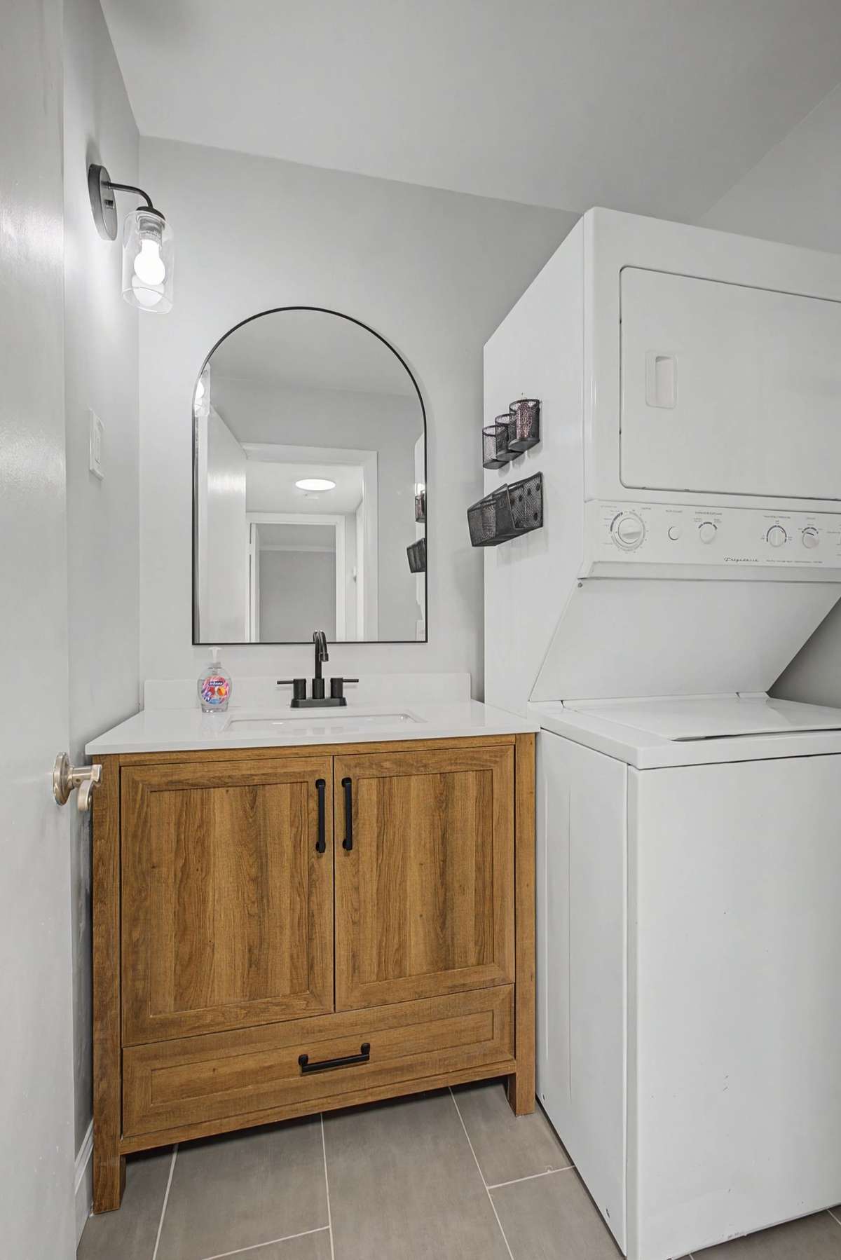 New vanity, fixtures, mirror, and LVP make this a perfect cozy bathroom. The stackable washer/dryer is perfectly placed, making laundry easy.