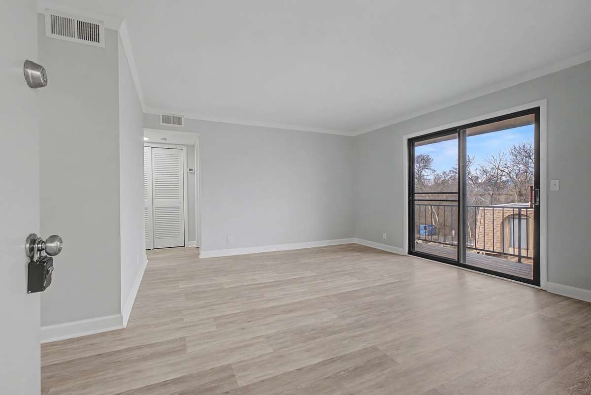 Spacious living room that steps out onto a deck that overlooks the pool!