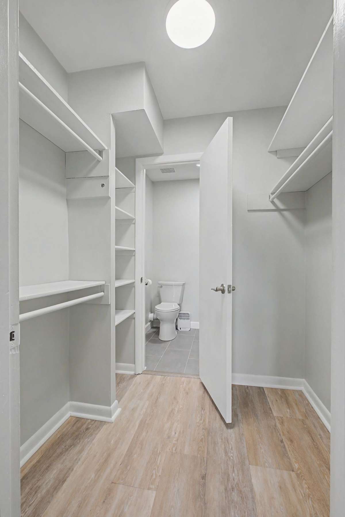 Walk-in closet leads into the bathroom that has been tastefully appointed.