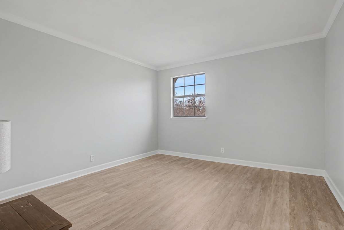 Large bedroom with window that overlooks the pool area.  New LVP and paint make this a fresh new look!