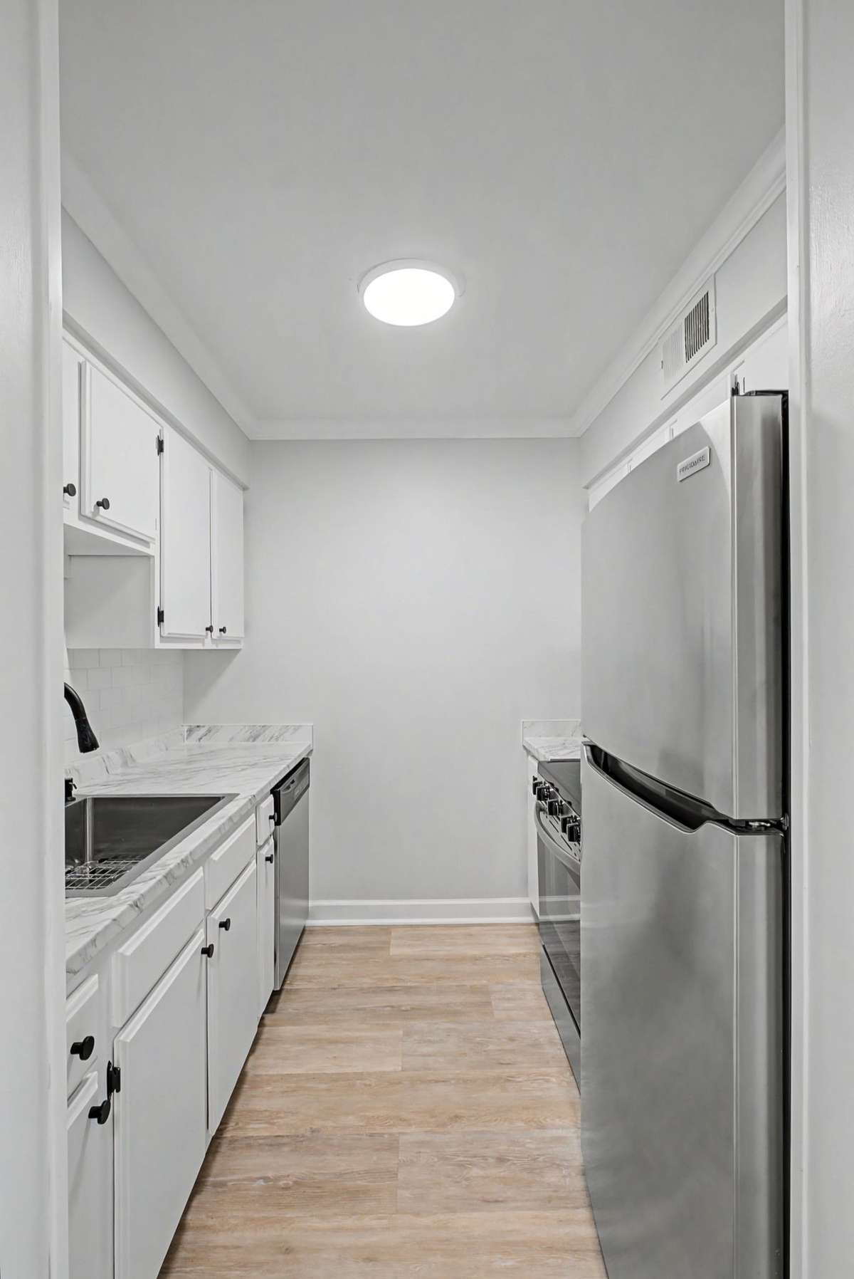Kitchen has been updated with new stainless steel appliances, new countertops and fixtures, and a new sink with sink grid.  All cabinets have been freshly painted.