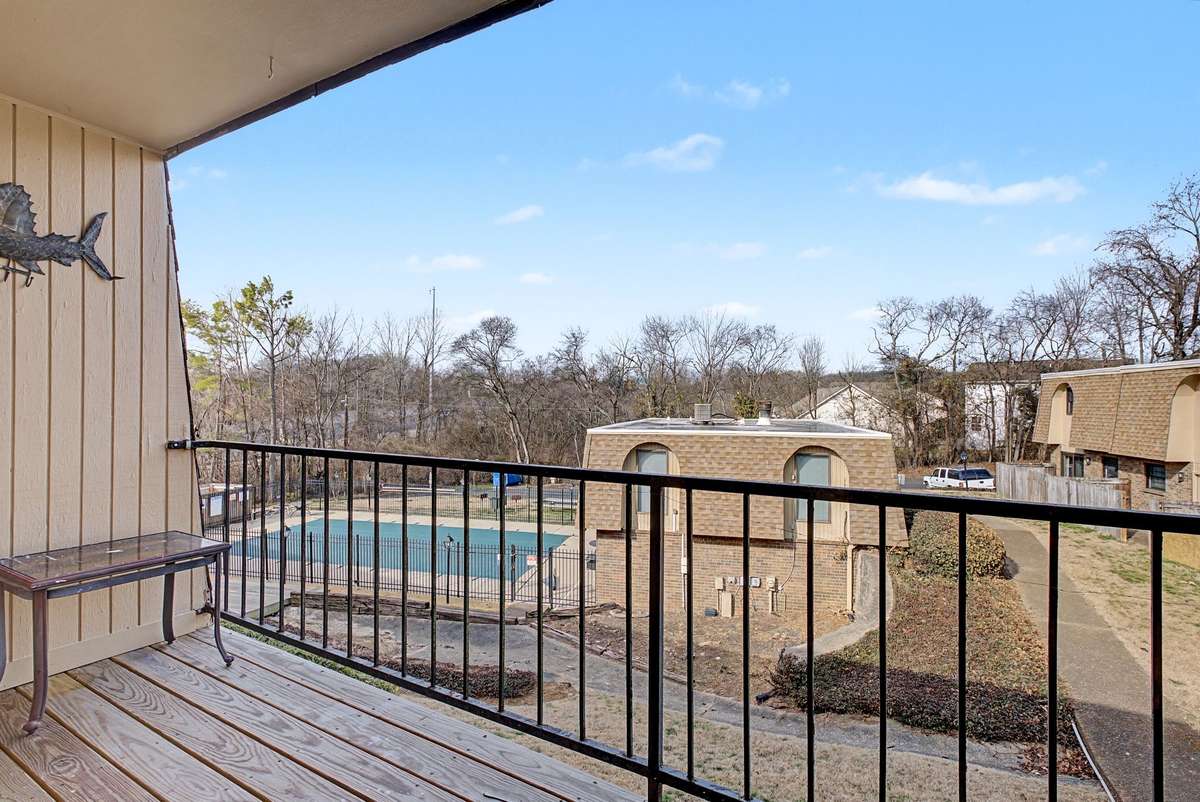 The spacious, private deck off the living room looks out onto the pool area.  Relax in the morning with coffee, or unwind in the evening.