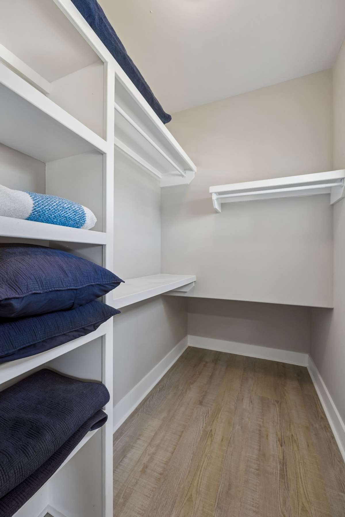 Closet with tuck away storage for suitcases.