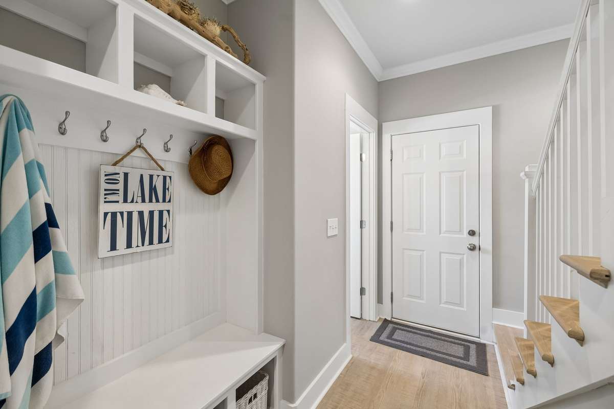 Garage opening directly to a half bath, mudroom, & laundry room.