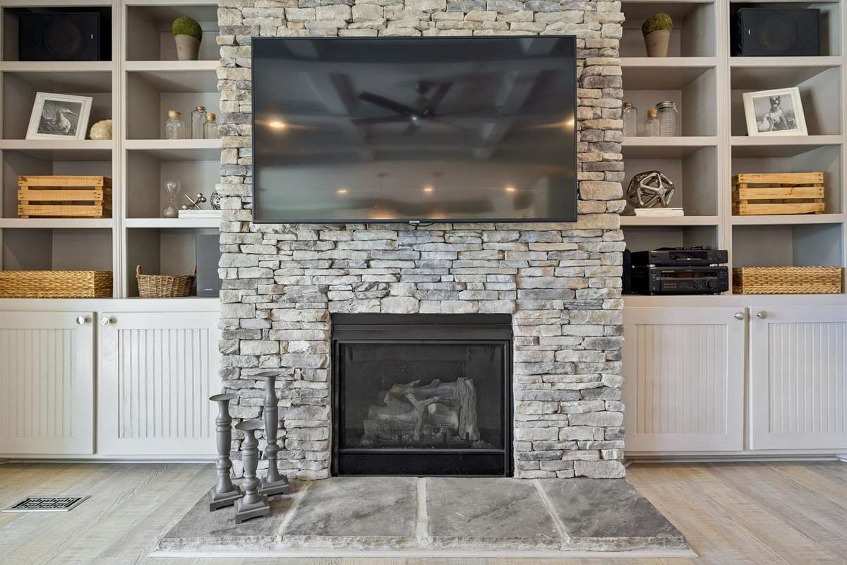 Custom fireplace. All T.Vs stay by the way!