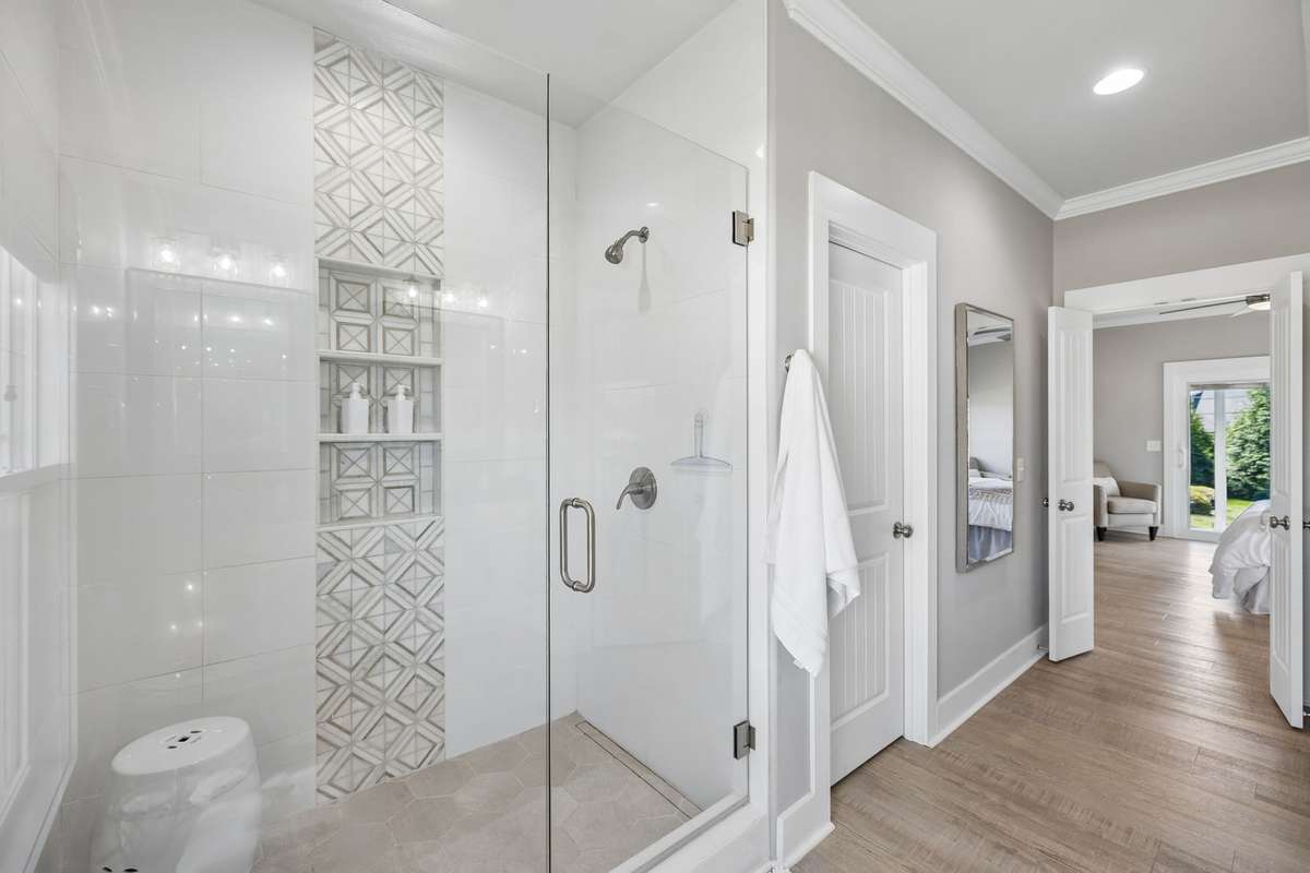 Deluxe walk in shower and owner's closet with a lock