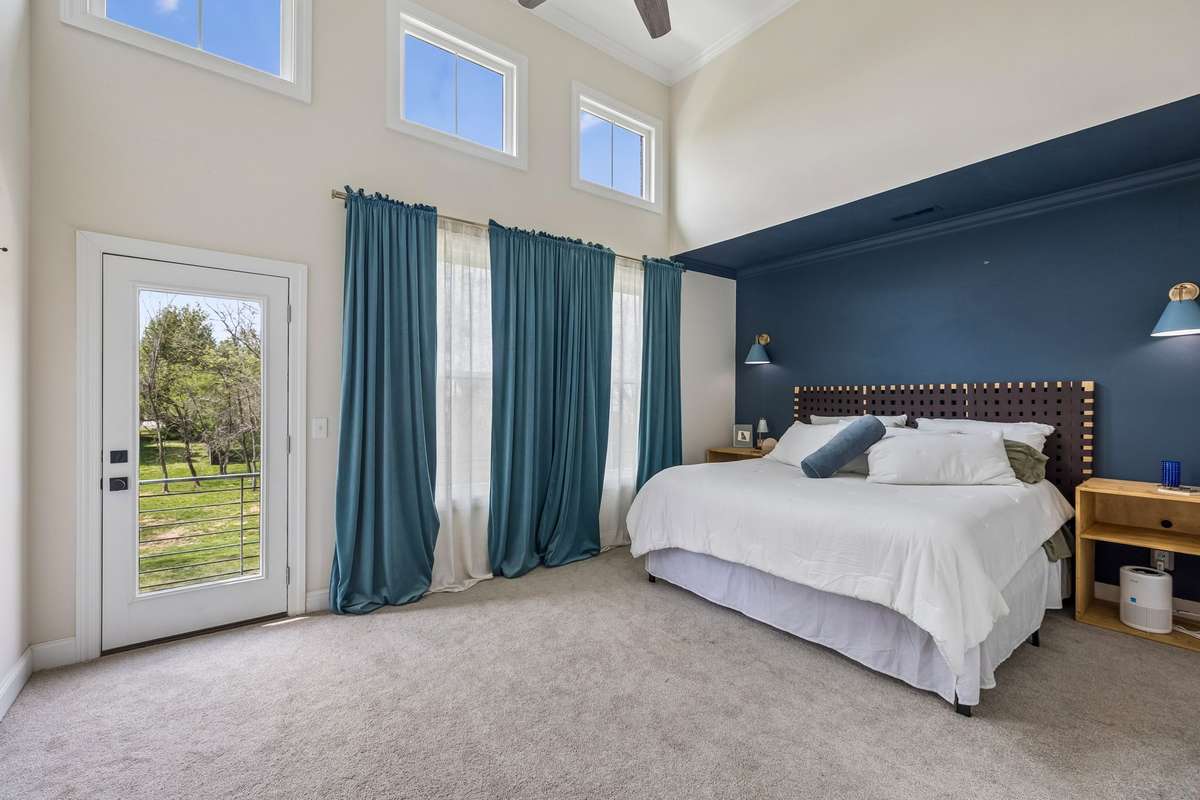Primary Bedroom Suite with Raised Ceilings, Plenty of Natural light and a Balcony to enjoy the fresh morning air.