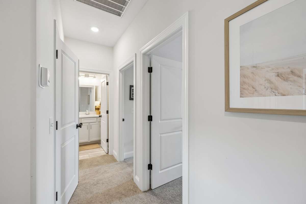 Hallway leading to additional Guest Rooms,  Hall Bath and Laundry Closet