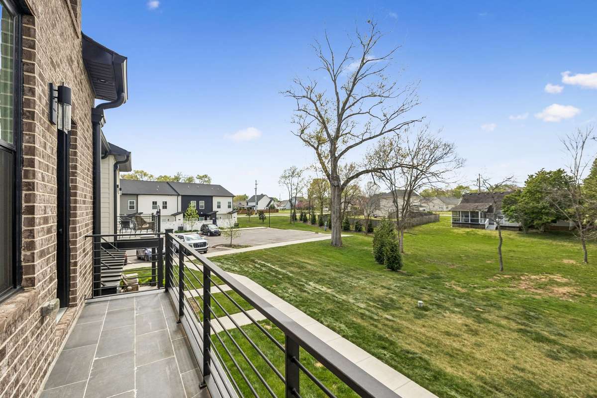 Private Balcony off of Primary Bedroom overlooking quiet grassy area