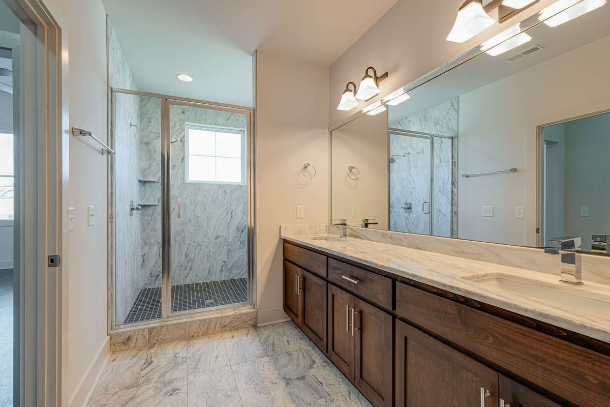 Master Bathroom with double vanity and walk-in shower.
